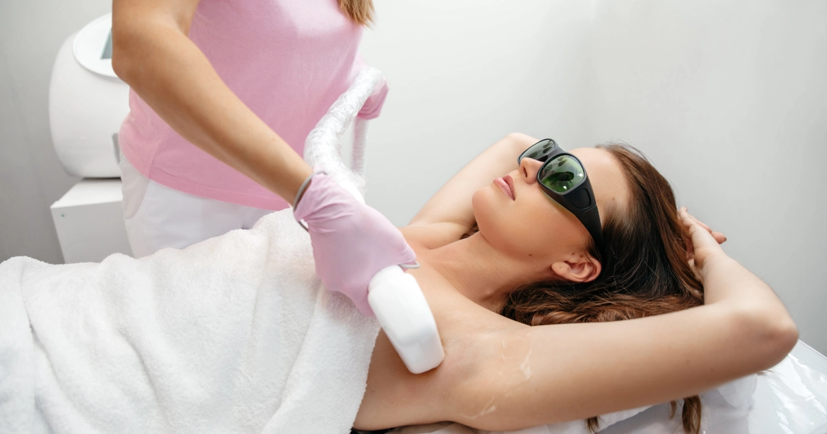 Client receives underarm laser hair removal with protective goggles at a clinical spa in Minneapolis, Fridley, and Edina, MN.