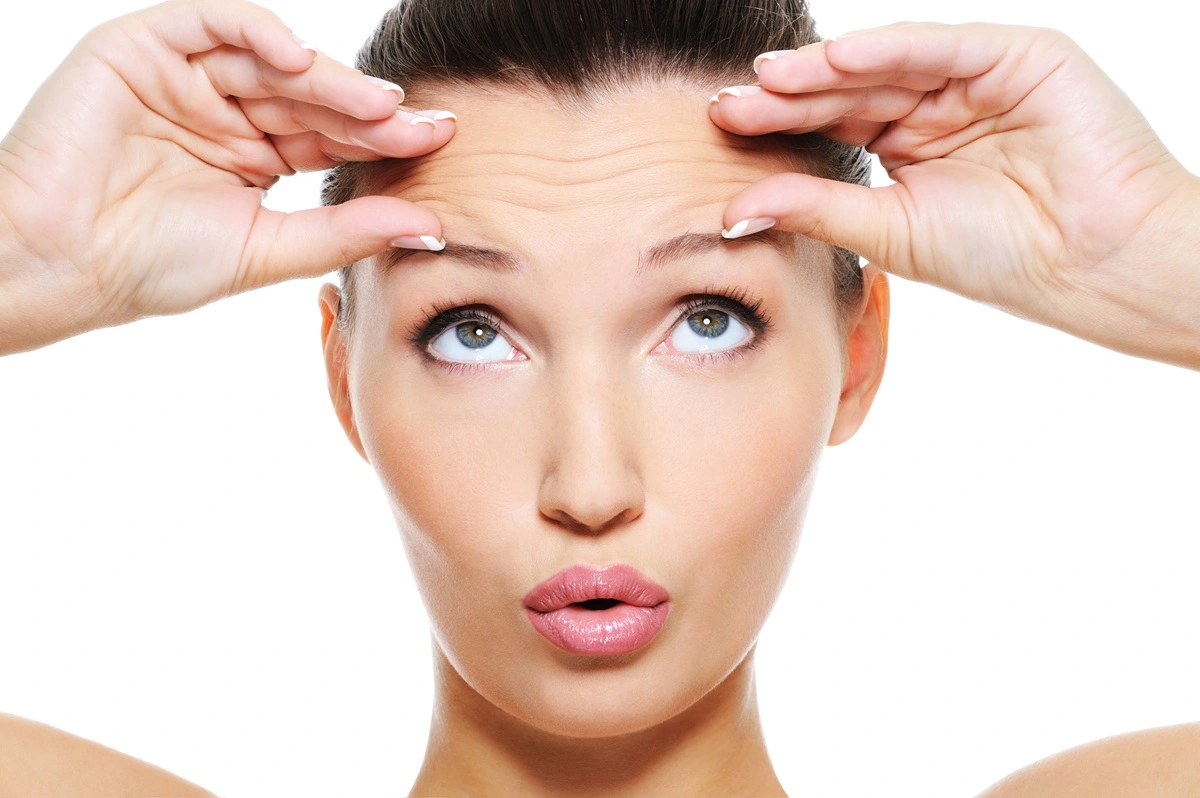 Woman showing forehead expression lines illustrating preventative Botox treatment at Afzal Clinics in Edina, Minneapolis, and Fridley, MN